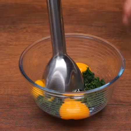 К подготовленному шпинату насыпаем 1/3 ч. л. соли и добавляем 3 желтка.