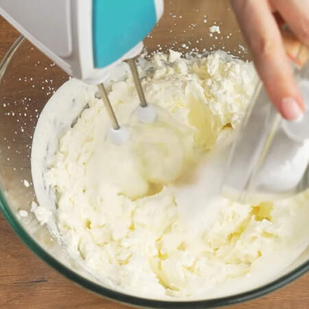 Добавляем к сливочно-сырной массе сахарную пудру, не прекращая взбивание.