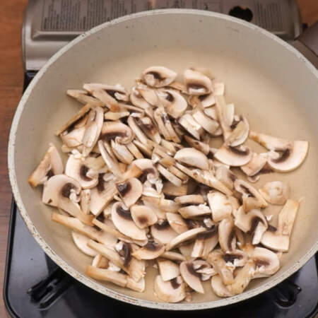 Подготовленные грибы кладем на разогретую сковороду и жарим на большом огне до испарения жидкости. 
