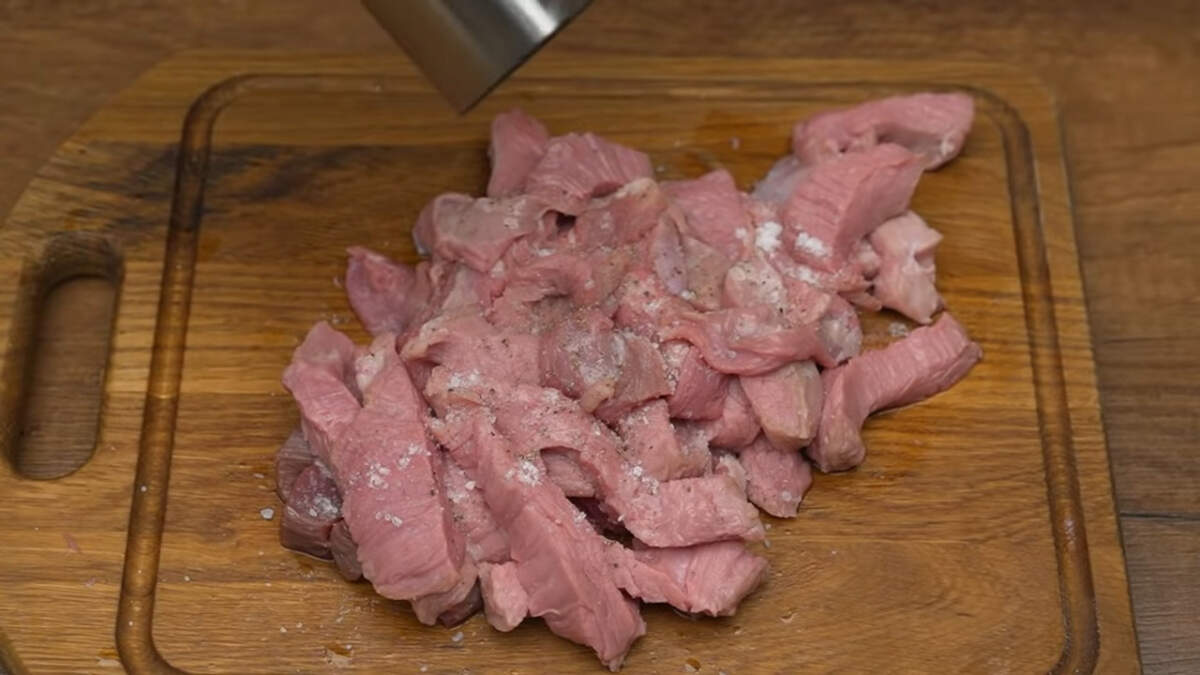 Мясо солим по вкусу и перчим. Приправы распределяем руками по мясу.