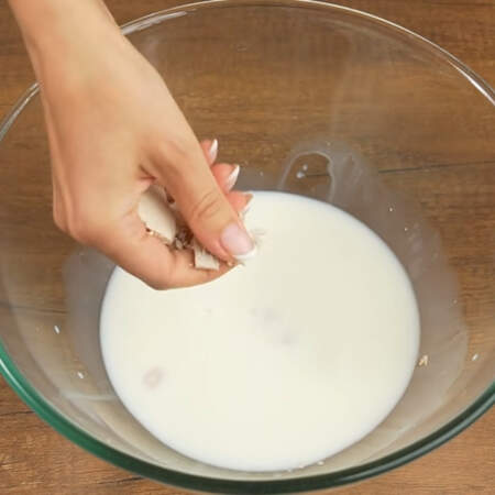 Сначала приготовим тесто для булочек.
В миску наливаем 250 мл молока и крошим в него 15 г прессованных дрожжей. Вместо прессованных дрожжей можно использовать сухие, их понадобится 5 г. Сюда же насыпаем примерно 2 ст. л. сахара. И добавляем щепотку соли.