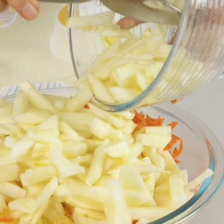 Натертую морковь и нарезанные яблоки выкладываем в миску к капусте с апельсинами. 