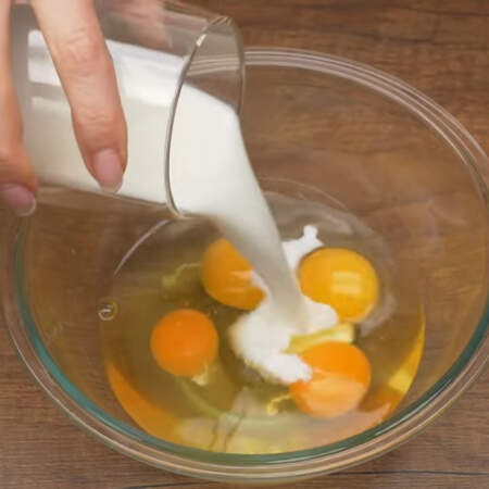 В миску разбиваем 4 яйца, солим по вкусу и наливаем 100 мл молока. 