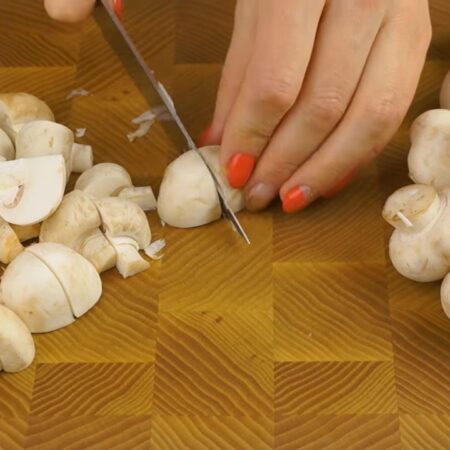 Сперва нарезаем грибы. 
Мелкие шампиньоны можно не разрезать, а более крупные разрезаем на 4 или более частей. 