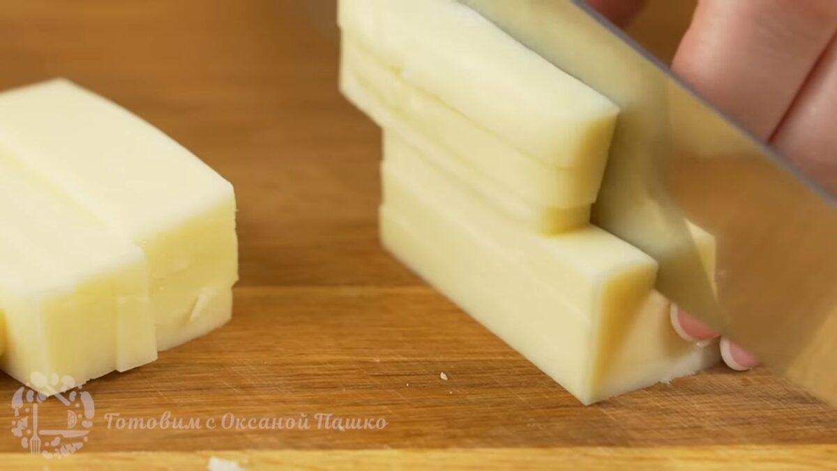 Пока выпекаются язычки подготовим сыр.
Берем примерно 150-200 г сыра, который хорошо плавится и нарезаем его небольшими пластинками или брусочками.
