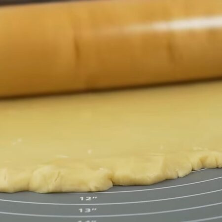 Подготовленное белое тесто вынимаем из холодильника и раскатываем в пласт. Края теста подравниваем края руками. Раскатываем не сильно тонко, толщина теста должна быть примерно 4-6 мм. 